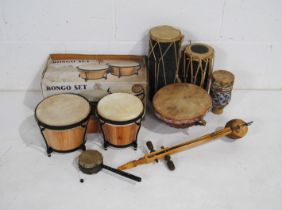 A collection of various tribal drums & percussion instruments, including a boxed set of bongos and a