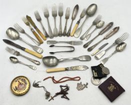 A collection of items including silver cross, coral necklace, coins, silver plated cutlery etc.