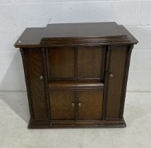 A singer treadle sewing machine in oak cabinet