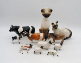 A collection of mostly Beswick animal figures, consisting of a Champion Coddington Hilt Bar Freisian