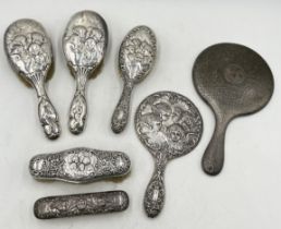 A collection of hallmarked silver dressing table mirrors and brushes