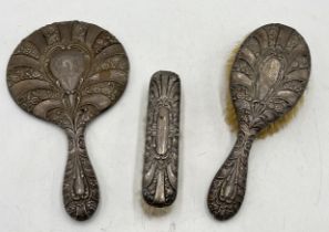 A hallmarked silver three piece dressing table set consisting of mirror and two brushes