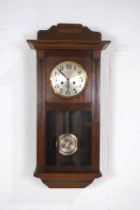An Edwardian oak cased wall clock, with key