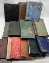 A collection of antique and other empty postcard albums