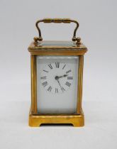 A brass carriage clock, marked 'LF'