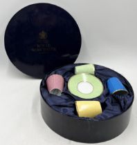 A boxed set of four Royal Worcester royal commemorative coffee cans and saucers "In Celebration of