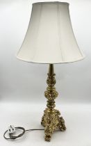 A large gilt table lamp on tripod base and scrolled feet - approx. 95cm