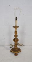 An Ecclesiastical style gilt table lamp, with carved acanthus decoration, raised on claw feet