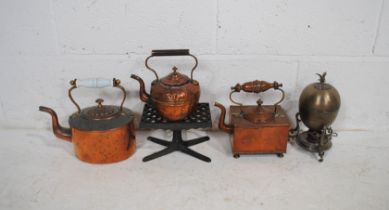 A mixed lot including three copper kettles, a cast iron stand etc.