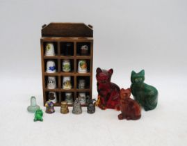 A small collection of thimbles, along with three stone cat figures etc.