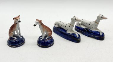 A pair of Staffordshire dalmatians along with a pair of Staffordshire style greyhounds on cushions