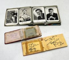 Three vintage autograph books, one filled with numerous signed postcards and the other two with