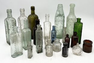 A collection of antique glass bottles including one for Buckler & Co. Exeter, Camp Coffee etc.