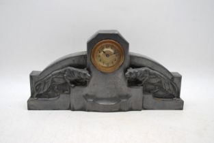 An Art Deco pewter mantel clock, the brass face surmounted by leopards - length 32cm, height 16cm