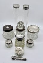 A collection of silver topped dressing table pots, scent bottle etc.