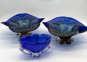 A large pair of art glass dishes in blue, possible Murano, along with a smaller blue vase