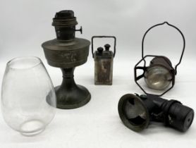 A collection of items including vintage carbide, oil lamp, accumulator and early example of a torch
