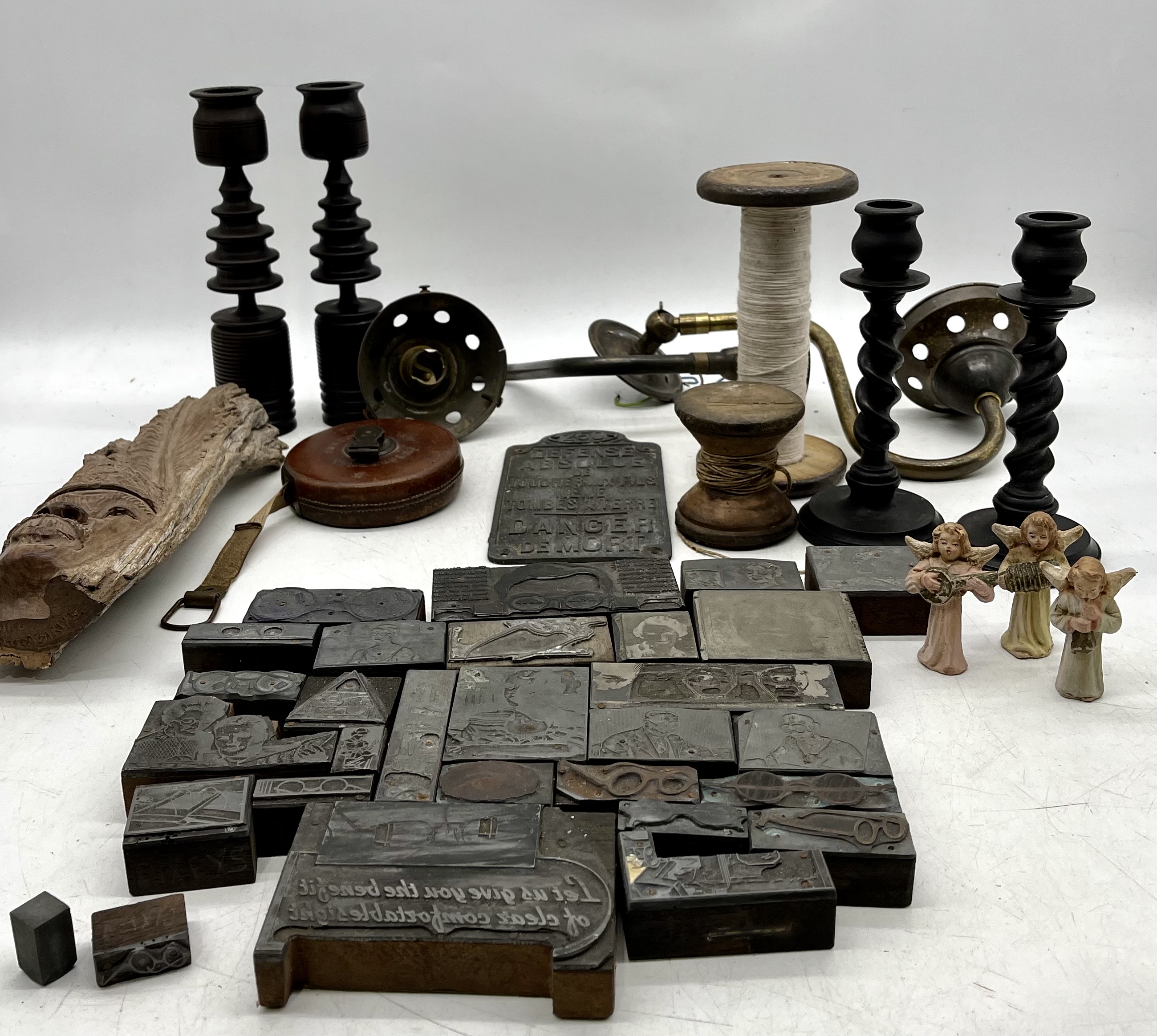 A miscellaneous lot including bobbins, ophthalmic themed woodblock printing blocks, candlesticks etc