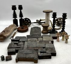 A miscellaneous lot including bobbins, ophthalmic themed woodblock printing blocks, candlesticks etc