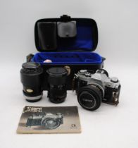 A vintage Canon AE-1 camera, with Canon 35-70mm lens, 50mm lens, 135mm lens, instructions and fitted