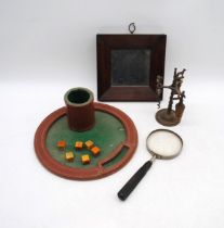 A small Victorian mahogany framed wall hanging mirror with distressed glass, along with a dice