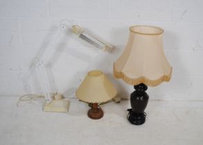 Two wooden table lamps, along with an angle-poise style adjustable lamp