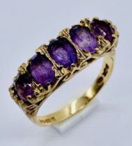 An amethyst five stone ring set in 9ct gold, size N