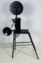 A 1930's hand crank film projector, a "Kalee Indomitable no 7" on hand made-stand