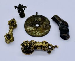 A bronze pipe tamper in the form of a horses hoof along with a Chinese figure of a tiger, a token