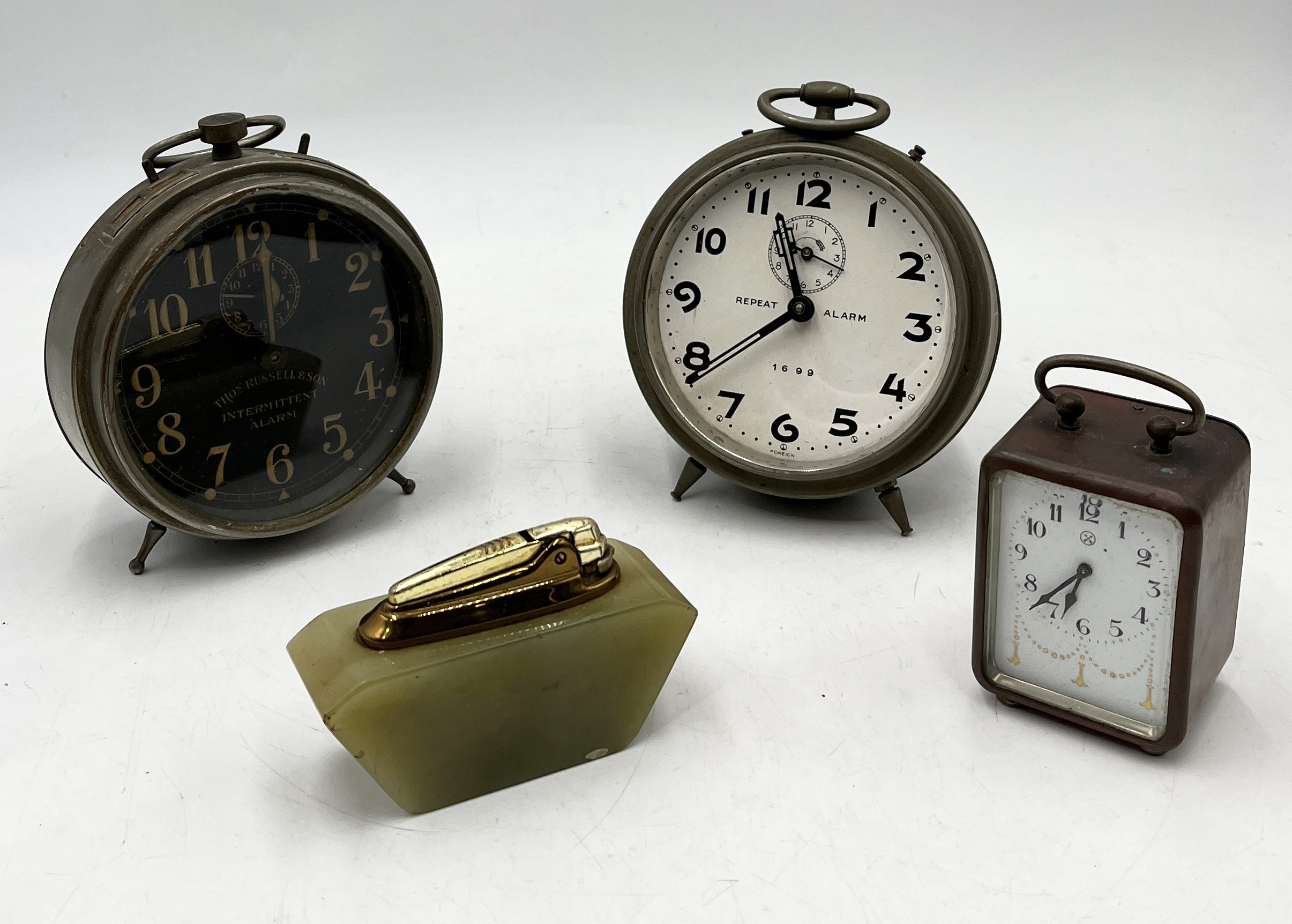 A collection of vintage alarm clocks including Thomas Russell & Sons along with an onyx Ronson