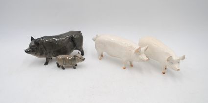 A Royal Doulton black pot-bellied pig with piglet, along with two Beswick pigs - Champion Wall Boy
