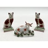 A small Staffordshire figure of a cow along with a pair of Staffordshire cats (1 A/F)