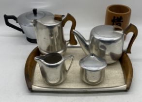 A Picquot brushed aluminium tea set with original tray along with an Art Deco tea pot etc.
