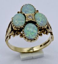 A 9ct gold ring set with opals and a central diamond, size O 1/2