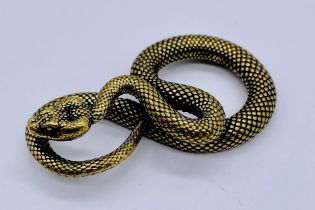 A small brass model of a coiled snake, approx. 5.25cm length