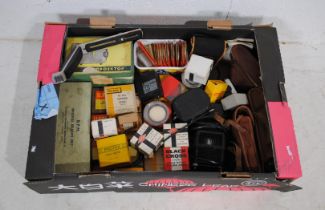 A collection of vintage cameras and accessories, including Canon, Paxina, Kodak etc.