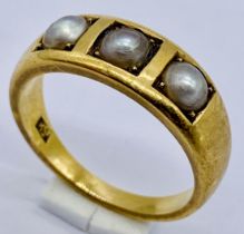 An 18ct gold ring set with three pearls, weight 5.7g, size M