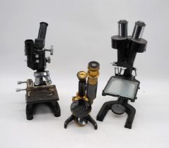 An antique brass microscope, marked 'Heath Optician, Plymouth', along with two other microscopes, "