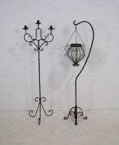 A wrought iron three branch candelabra, along with a wrought iron candle holder