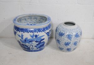 A large Chinese blue and white fish bowl vase, along with a ginger jar