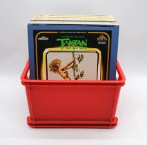 A collection of approximately twenty vintage film video laser discs, including Tarzan, Roobarb and