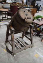 An antique wooden barrel butter churn, manufactured by 'Frank Buck' of Wincanton, with various prize