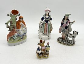 A collection of Staffordshire figures and spill vases including Scottish man dog etc.