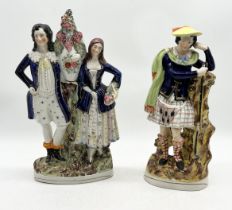 Two large Staffordshire flat back figures of a Scotsman and a man and a woman with vase of flowers