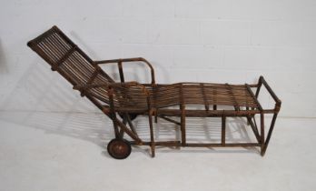 A vintage Continental plantation style wooden sun lounger