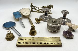 An assortment of items including brass cribbage board, vanity brushes, silver plated candlesticks