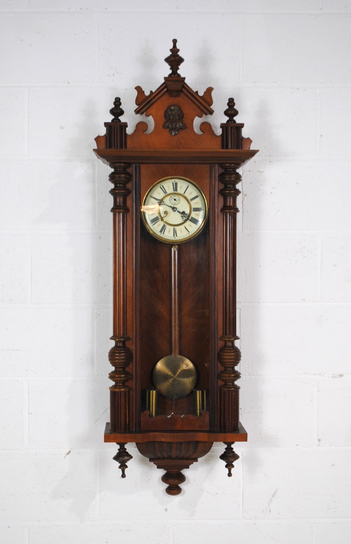 A mahogany cased eight day Vienna regulator wall hanging clock, with carved decoration and turned