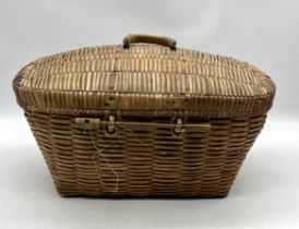 A lidded wicker basket with handle