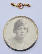 A small 9ct gold brooch, weight 1.1g along with a small hallmarked silver photo frame