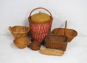 A wicker laundry basket, along with other various sized wicker baskets